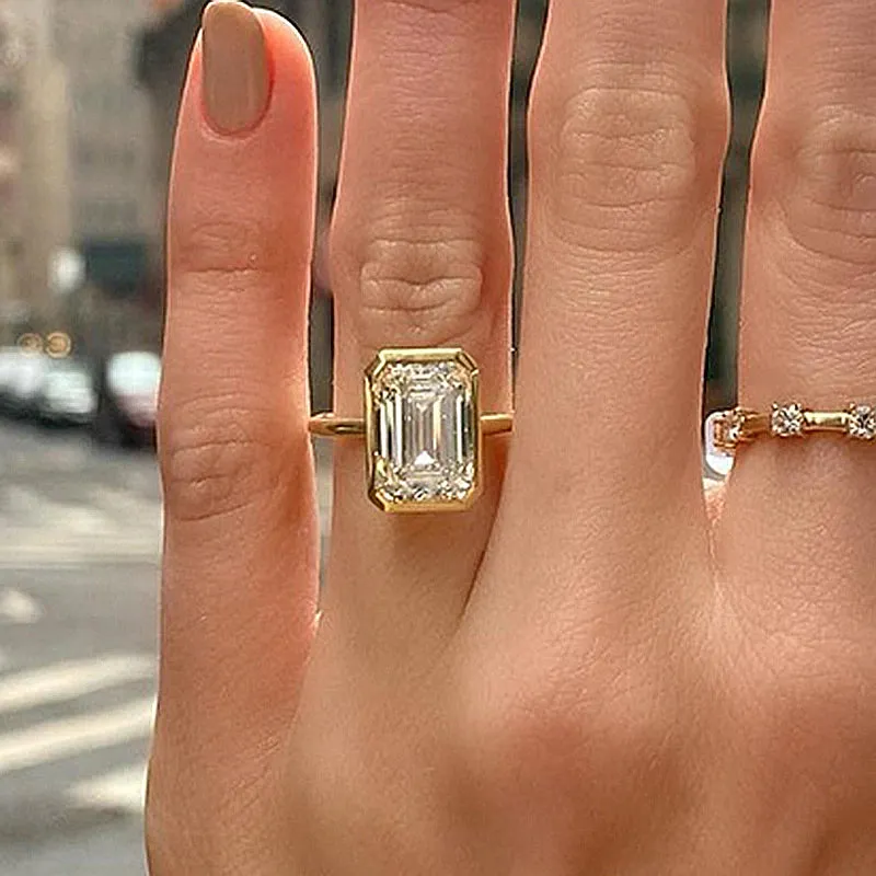 Elegant Emerald Cut Sterling Silver Bezel Engagement Ring In Golden Tone